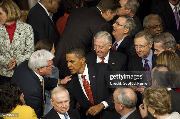 President Barack Obama arrives to deliver his first State of the Union address to a joint session of the U.S. Congress. Behind him are House Majority...