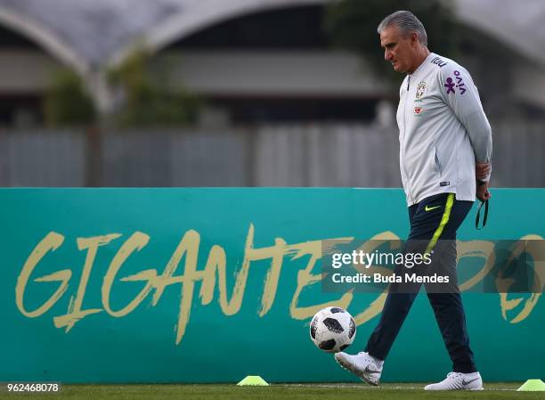 Head coach Tite kicks the ball during a training session of the Brazilian national football team at the squad's Granja Comary training complex on May...