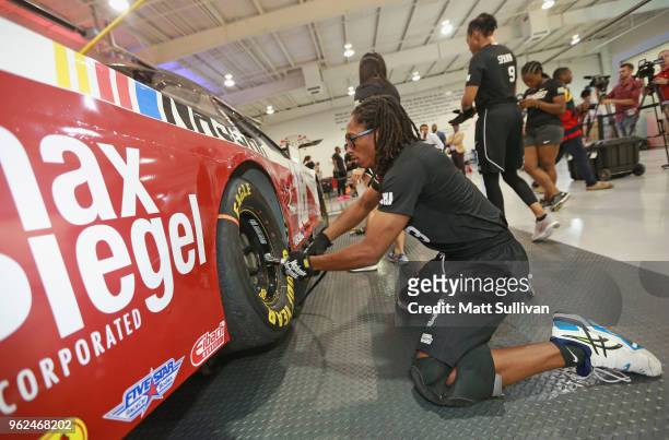 Keiston France changes a tire during the NASCAR Drive for Diversity Combine at the NASCAR Research and Development Center on May 25, 2018 in Concord,...