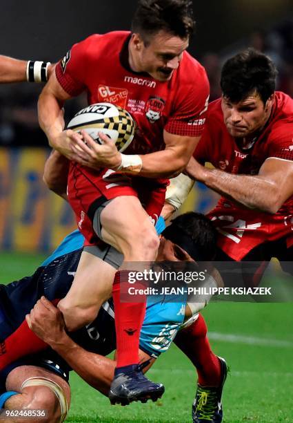 Montpellier's French flanker Kelian Galletier vies with Lyon's New Zealander winger Toby Arnold during the French Top 14 union semi-final rugby match...