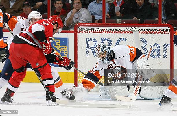Rick DiPietro of the New York Islanders makes a save on a shot by Stephane Yelle of the Carolina Hurricanes during a NHL game on January 28, 2010 at...