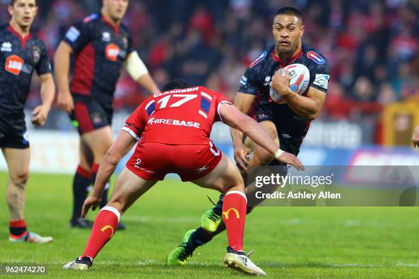 Willie Isa of Wigan Warriors runs with the ball as Chris Clarkson of Hull KR moves in during the Betfred Super League at KCOM Craven Park on May 25,...