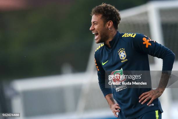 Neymar smiles during a training session of the Brazilian national football team at the squad's Granja Comary training complex on May 25, 2018 in...