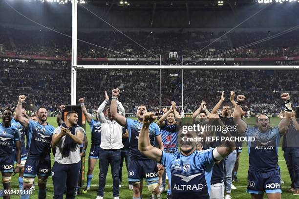 Montpellier's players celebrate their victory at the end of the French Top 14 union semi-final rugby match between Montpellier and Lyon on May 25,...