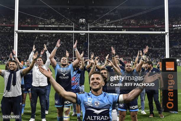 Montpellier's players celebrate their victory at the end of the French Top 14 union semi-final rugby match between Montpellier and Lyon on May 25,...