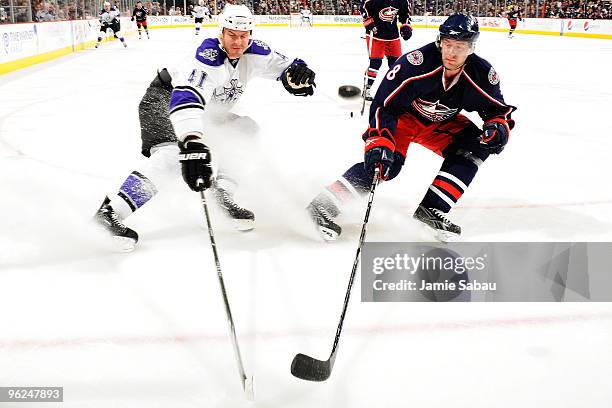 Jan Hejda of the Columbus Blue Jackets and Raitis Ivanans of the Los Angeles Kings chase down a loose puck during the second period on January 28,...