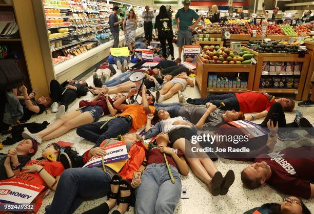 Protesters participate in a "die'-in" protest in a Publix supermarket on May 25, 2018 in Coral Springs, Florida. The activists many of whom are...