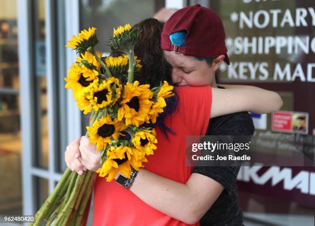 Caspen Becher a freshman at Marjory Stoneman Douglas High School is hugged as she joins with others for a "die'-in" protest in a Publix supermarket...