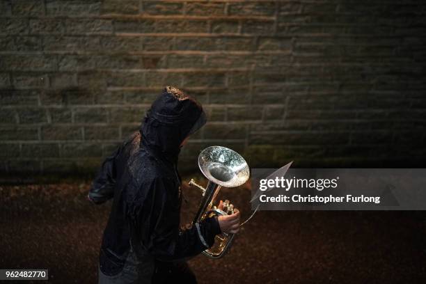 Young band members brave the rain as they prpepare to play in the village of Delph as they compete in the Whit Friday brass band competition on May...