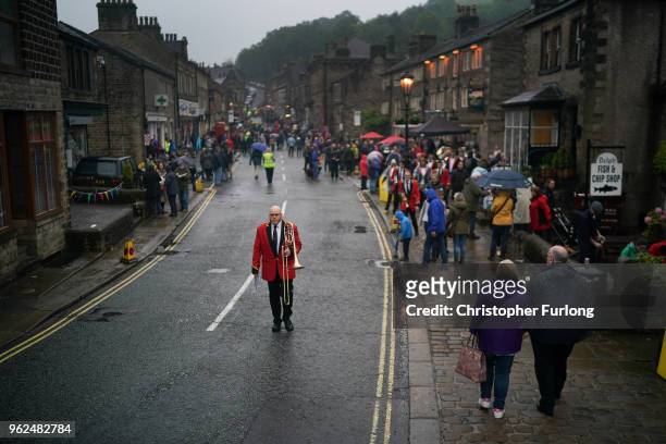 Members of the Flookburgh Band walk through the village of Delph as they compete in the Whit Friday brass band competition, on May 25, 2018 in...