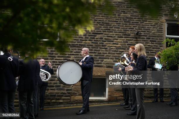 Brass band members brave the rain as they play in the Whit Friday brass band competition, in the village of Dobcross, on May 25, 2018 in Oldham,...