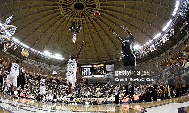 Al-Farouq Aminu of the Wake Forest Demon Deacons shoots a three-point basket over D'Andre Bell of the Georgia Tech Yellow Jackets at Alexander...