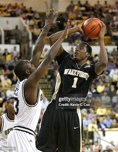 Al-Farouq Aminu of the Wake Forest Demon Deacons shoots over D'Andre Bell of the Georgia Tech Yellow Jackets at Alexander Memorial Coliseum on...