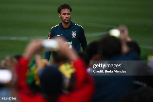 Neymar walks toward the fans after a training session of the Brazilian national football team at the squad's Granja Comary training complex on May...