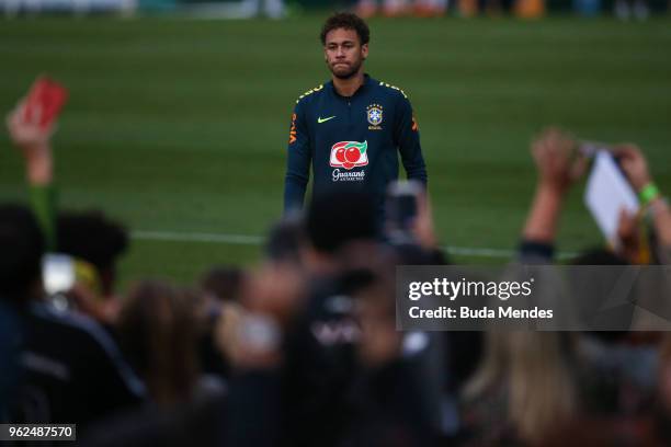 Neymar walks toward the fans after a training session of the Brazilian national football team at the squad's Granja Comary training complex on May...