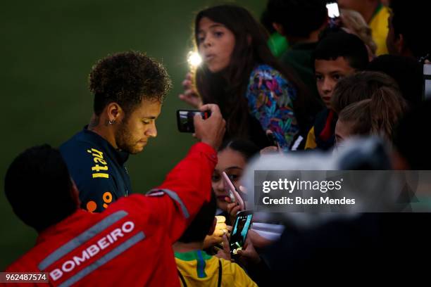 Neymar signs autographs to supporters after a training session of the Brazilian national football team at the squad's Granja Comary training complex...