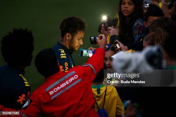 Neymar signs autographs to supporters after a training session of the Brazilian national football team at the squad's Granja Comary training complex...