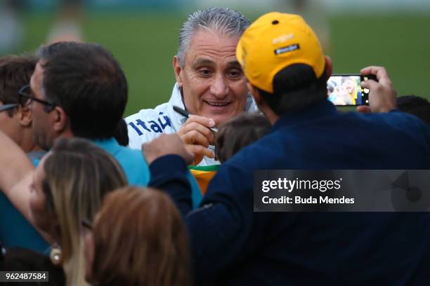 Head coach Tite signs autographs to supporters after a training session of the Brazilian national football team at the squad's Granja Comary training...