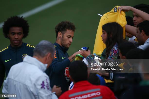 Neymar signs autographs to supporters after a training session of the Brazilian national football team at the squad's Granja Comary training complex...