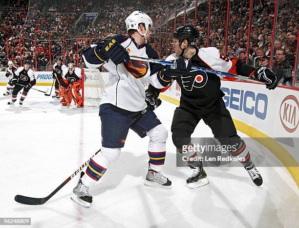Ole-Kristian Tollefsen of the Philadelphia Flyers battles in the corner with Eric Boulton of the Atlanta Thrashers on January 28, 2010 at the...