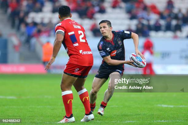 Ben Flower of Wigan Warriors shapes to pass the ball as Junior Vaivai of Hull KR looks on during the Betfred Super League at KCOM Craven Park on May...