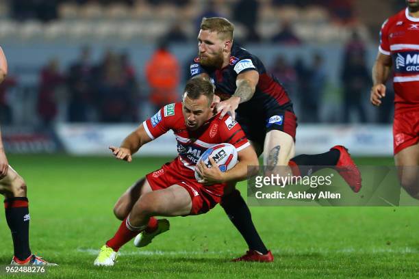 Sam Tomkins of Wigan Warriors tackles Adam Quinlan of Hull KR during the Betfred Super League at KCOM Craven Park on May 25, 2018 in Hull, England.