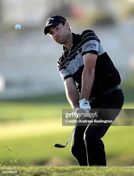 Oliver Wilson of England plays a chip shot on the 17th hole during the first round of the Commercialbank Qatar Masters at Doha Golf Club on January...