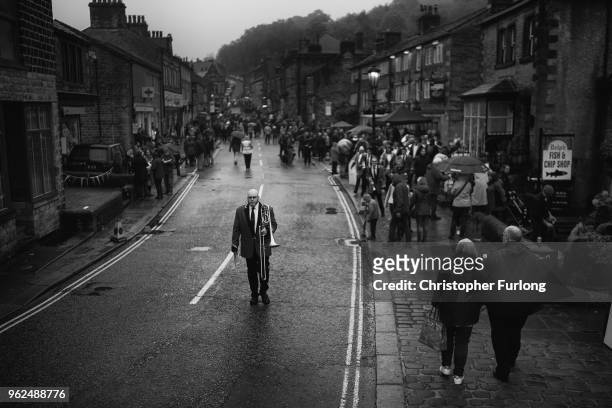 Members of the Flookborough Band walk through the village of Delph as they compete in the Whit Friday brass band competition, on May 25, 2018 in...