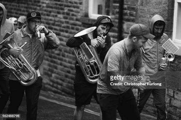 Chav Brass Band members take a beak as they compete in the Whit Friday brass band competition, in the village of Dobcross, on May 25, 2018 in Oldham,...