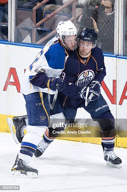 David Backes of the St. Louis Blues hits Sam Gagner of the Edmonton Oilers at Rexall Place on January 28, 2010 in Edmonton, Alberta, Canada. The...