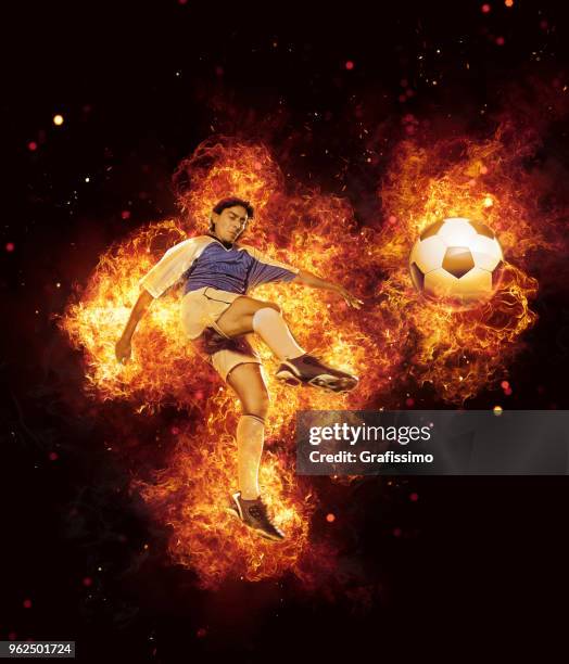 best soccer player kicking ball surrounded by fire and flames - hot latin nights stock pictures, royalty-free photos & images