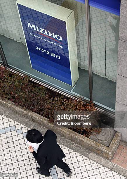 Pedestrian walks past a Mizuho Bank Ltd. Branch in Tokyo, Japan, on Friday, Jan. 29, 2010. Mizuho Financial Group Inc. Is Japan's third-biggest bank...