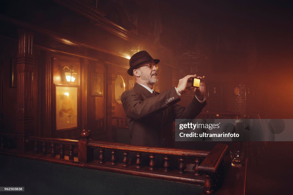 Retro pub Old-fashioned lifestyle senior men portrait Active senior using smartphone