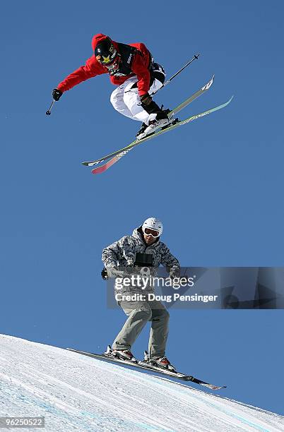 Sammy Carlson of Hood River, Oregan does an aerial maneuver above the skiing television cameraman as he descends the course during the Men's Skiing...