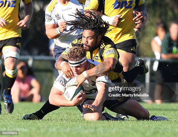 Michael Hooper of the Brumbies gets tackled by Ma'a Nonu of the Hurricanes during a Super 14 Trial match between the Hurricanes and the Brumbies at...
