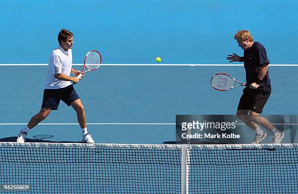 Mark Woodforde of Australia plays a backhand in his legends doubles match with Todd Woodbridge of Australia against Guy Forget and Cedric Pioline of...