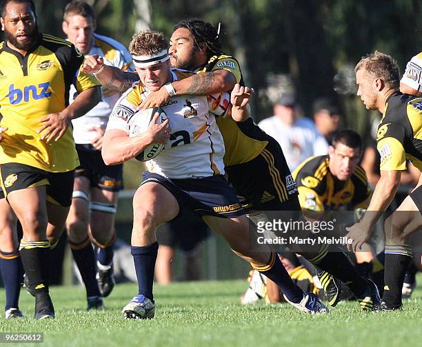 Michael Hooper of the Brumbies gets tackled by Ma'a Nonu of the Hurricanes during a Super 14 Trial match between the Hurricanes and the Brumbies at...