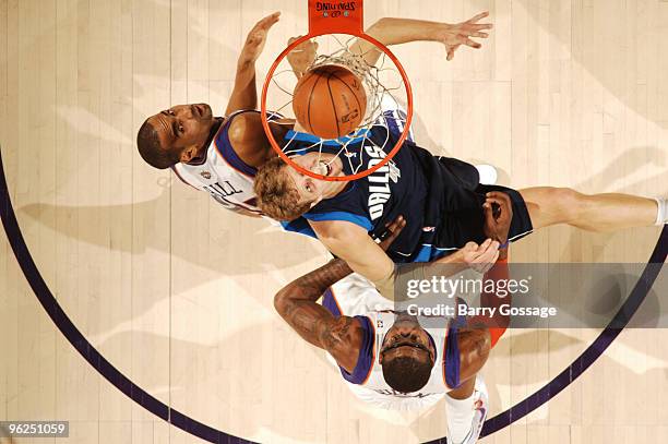 Grant Hill and Amare Stoudemire of the Phoenix Suns watch a basket drop by Dirk Nowitzki of the Dallas Mavericksin an NBA Game played on January 28,...