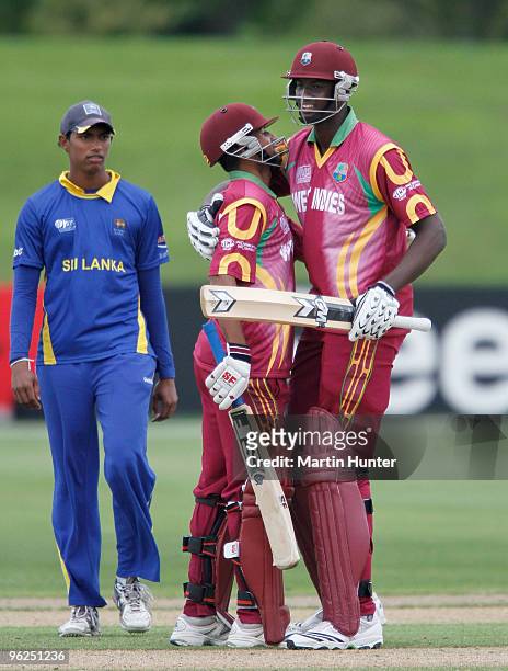 Yannic Cariah of the West Indies celebrates with his team mate Jason Holder during the ICC U19 Cricket World Cup Super League quarter final between...