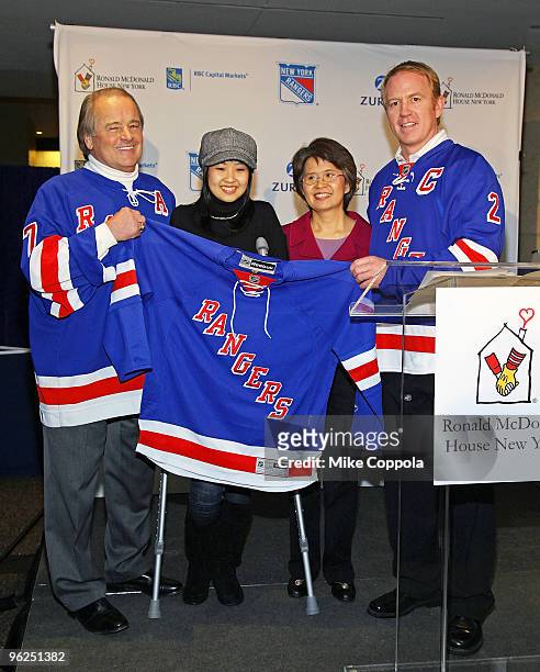 Former New York Rangers hockey players Rod Gilbert and Brian Leetch present a jersey to a patient and her monther at the 16th Annual Skate With The...