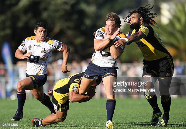 Ed Stubbs of the Brumbies is tackled by Ma'a Nonu and Alapai Leiua of the Hurricanes during a Super 14 Trial match between the Hurricanes and the...