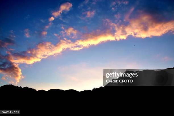 Photo taken on 25 May 2018 shows the sunset glow tints the sky red in Congjiang county, China's Guizhou province.