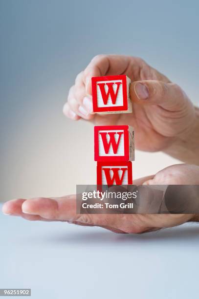 hands holding block with www - www w w w w stockfoto's en -beelden