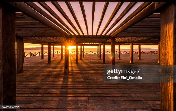 sunset in trabucador beach dock. spain - delta do rio ebro imagens e fotografias de stock