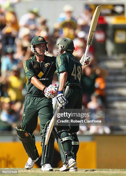 Nathan Hauritz of Australia celebrates his fifty runs with Michael Hussey during the fourth One Day International match between Australia and...