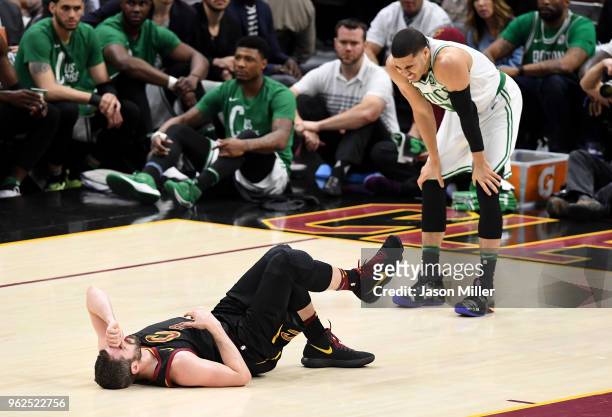 Kevin Love of the Cleveland Cavaliers lies on the court as Jayson Tatum of the Boston Celtics reacts after colliding in the first quarter during Game...