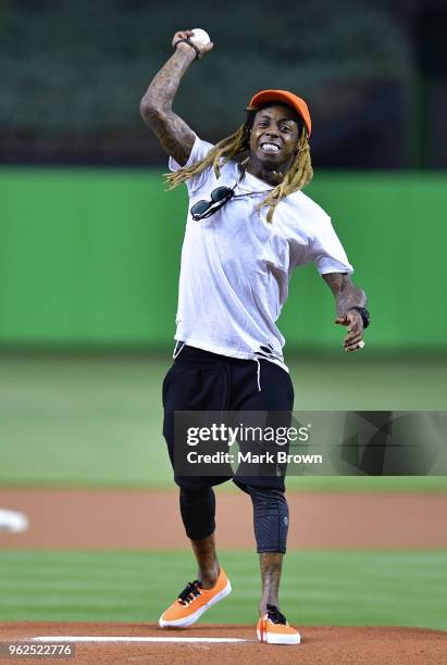 Hip Hop artist Lil Wayne throws out the first pitch before the game between the Miami Marlins and the Washington Nationals at Marlins Park on May 25,...