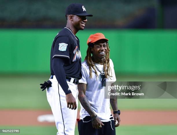 Hip Hop artist Lil Wayne poses with Lewis Brinson of the Miami Marlins after throwing out the first pitch before the game between the Miami Marlins...