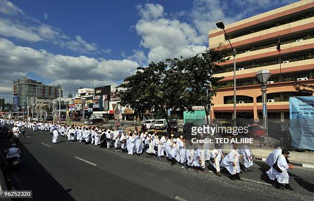 Thousands of Roman Catholic priests march on the streets of Manila on January 29 on their way to a stadium to celebrate mass at the conclusion of...