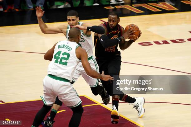 LeBron James of the Cleveland Cavaliers handles the ball against Jayson Tatum of the Boston Celtics in the first quarter during Game Six of the 2018...